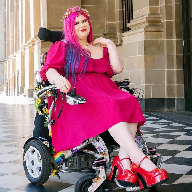 Zoe Simmons, on her wheelchair outdoors