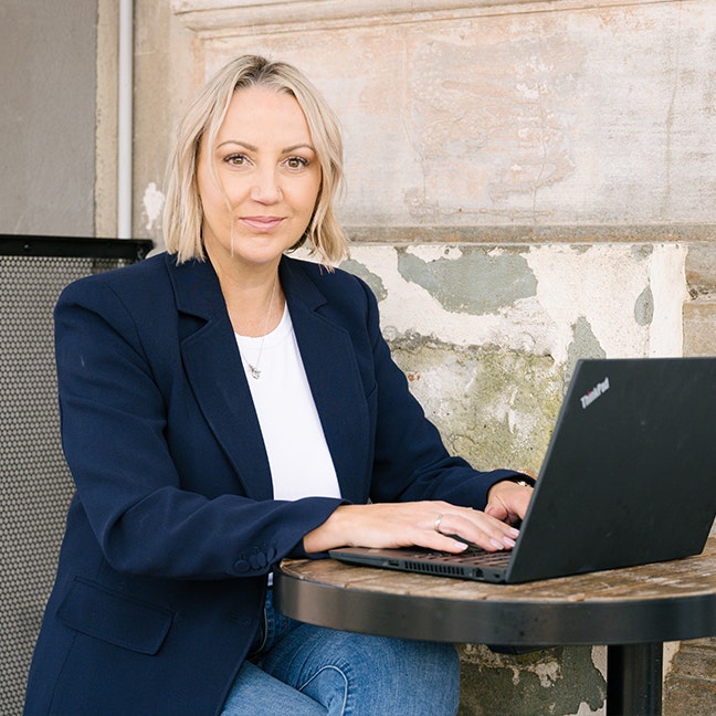 Beck, Business Relationship Manager in Plan Partners, working on her laptop